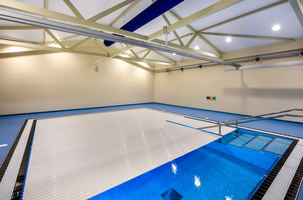 Modern indoor swimming pool facility with retractable cover