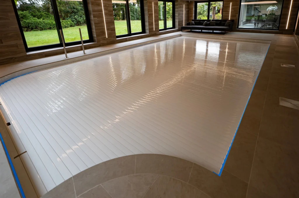 Indoor swimming pool with retractable cover in modern home