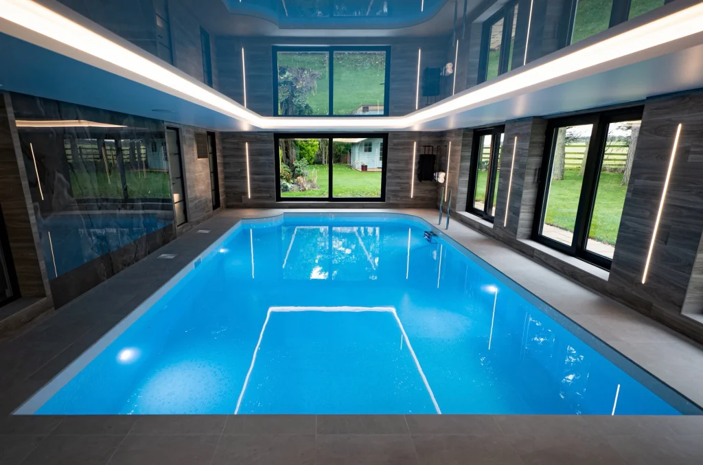 Modern indoor swimming pool with blue water and LED lighting
