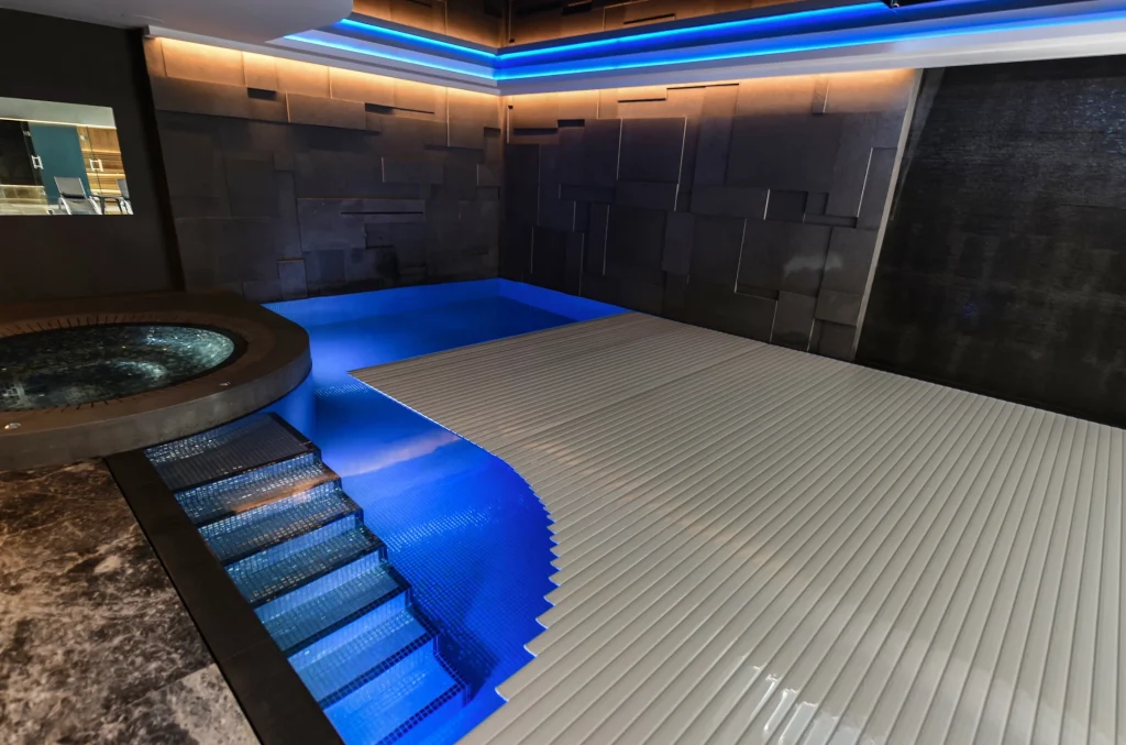 Modern spa pool area with blue lighting and wooden decking