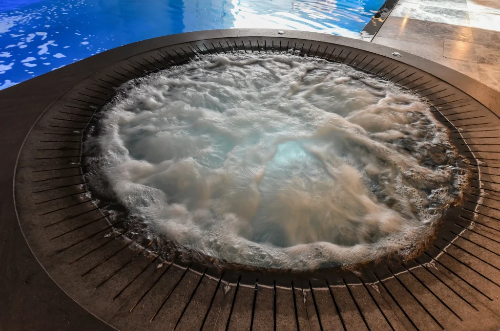 Bubbling hot spring spa pool with wooden decking
