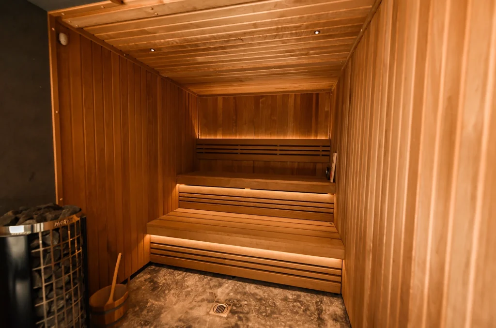 Modern wooden sauna interior with tiered benches and warm lighting