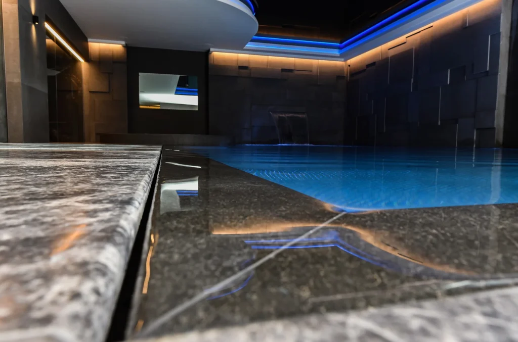 Modern luxury indoor swimming pool with blue LED lighting